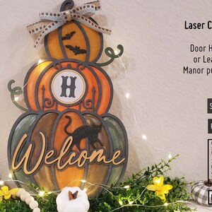 May include: A wooden Halloween door hanger shaped like stacked pumpkins. The top pumpkin has bats and a ribbon. The middle pumpkin has the letter "H". The bottom pumpkin says "Welcome" and has a black cat. The text "Laser Cut Files" is also visible.