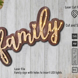 May include: A wooden sign with the word "family" in a cursive font. The sign has holes for lights and a distressed brown finish.