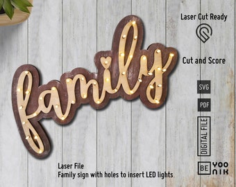 May include: A wooden sign with the word "family" in a cursive font. The sign has holes for lights and a distressed brown finish.