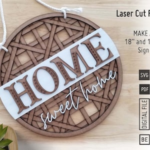 May include: A laser cut wooden sign with a white background and the words "HOME sweet home" in brown lettering. The sign is 18 inches and 10.5 inches and is available in SVG and PDF formats.