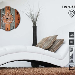 May include: A wooden clock with a rustic design featuring the words "God is good all the time". The clock is made of multiple wood pieces in shades of brown and blue. The clock is hanging on a white wall.
