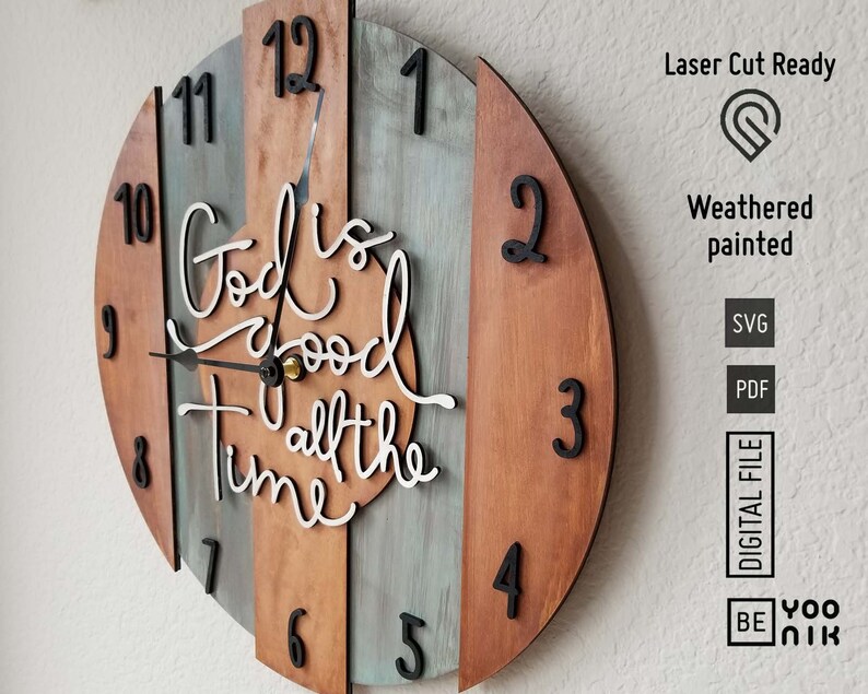 May include: A wooden clock with a weathered painted finish and a white inscription that reads "God is good all the time". The clock face has black Roman numeral hour markers and black hands.