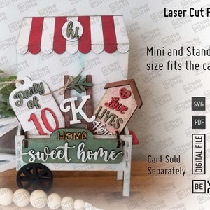 May include: A white wooden cart with red and white striped awning, decorated with various wooden signs. The signs say "Party of 10", "K", "Home Sweet Home", and "Love Lives Here".