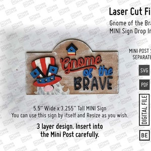 May include: A 3-layer laser cut design for a wooden sign that says "Gnome of the Brave". The sign is 5.5 inches wide and 3.255 inches tall. It features a gnome wearing a red, white, and blue hat with stars and stripes. The sign is designed to fit into a mini post, sold separately.