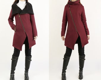 May include: A burgundy asymmetrical zippered coat with a black faux fur collar. The coat has a long, flowing silhouette and is perfect for layering in colder weather.