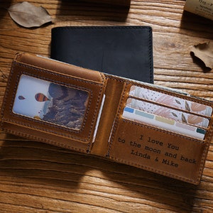 a wallet with a picture inside of it on a table