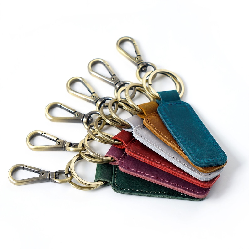 a bunch of different colored leather keychains on a white background