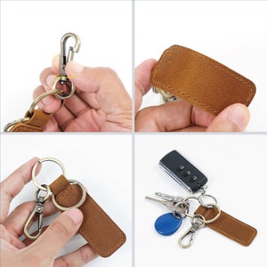 May include: A brown leather keychain with a metal ring and a swivel clip. The keychain has a stitched edge and a blank leather patch.