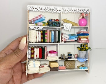 Dollhouse miniature sewing room shelving unit with worn-out effect complete with miniature supplies and accessories