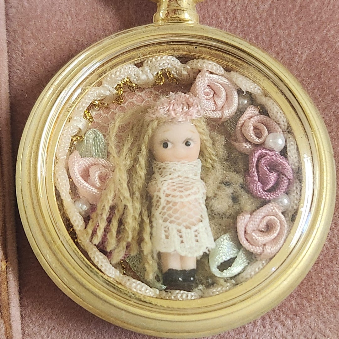 Marie Osmond Mini Bisque Kewpie Doll Pocket Watch Style Display marie-osmond-mini-bisque-kewpie-doll-pocket-watch-style-display