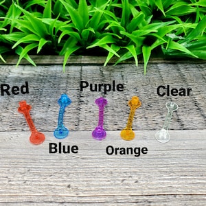 May include: Six plastic connectors in different colors: red, blue, purple, orange, clear. The connectors are labeled with their corresponding colors.