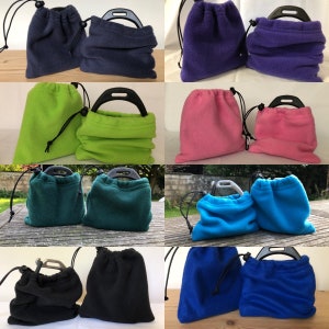 May include: A selection of fleece drawstring bags in shades of navy, purple, green, pink, teal, blue, black, and royal blue. Each bag features a black handle and drawstring closure.