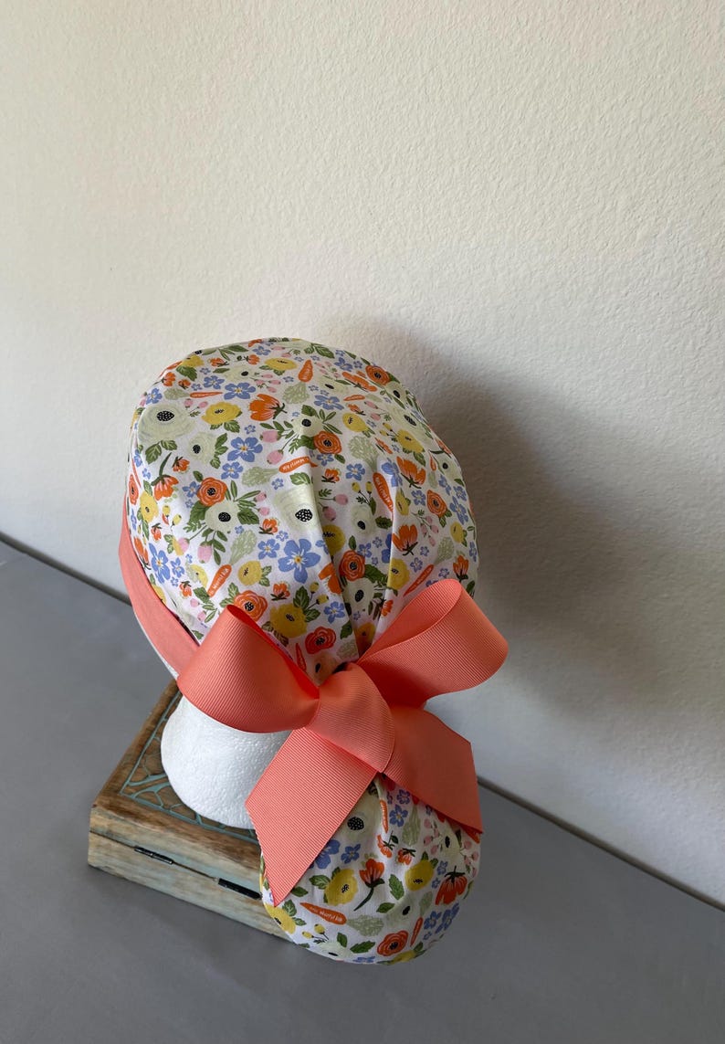 Avengers Ponytail Scrub Hat: Pediatric Nurse, Adjustable Buttons. Orange Carrot Flower
