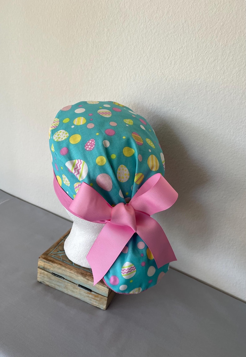 Avengers Ponytail Scrub Hat: Pediatric Nurse, Adjustable Buttons. Eggs on Blue
