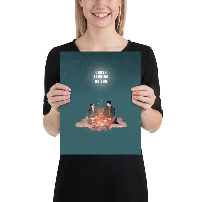 May include: A teal blue poster with a couple sitting by a campfire. The poster has the text "Crash Landing On You" in white.