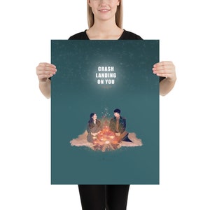 May include: A teal blue poster with a starry night sky background. The poster features a couple sitting by a campfire with the text "Crash Landing On You" in white.