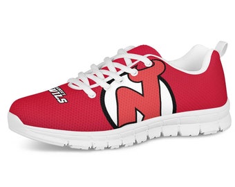 May include: Red and white athletic shoes with a red New Jersey Devils logo on the side. The shoes have white laces and a white sole.