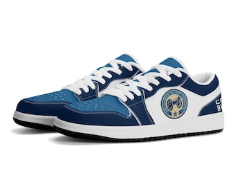 May include: A pair of blue and white sneakers with a logo featuring a cannon and the text "Columbus Blue Jackets".
