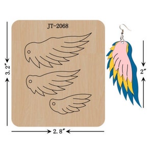 May include: A wooden die-cutting template with three wing shapes for crafting earrings. The template is 3.2 inches tall and 2.8 inches wide. The die-cut shapes are shown next to the template, with a finished earring in pink, yellow, and blue.