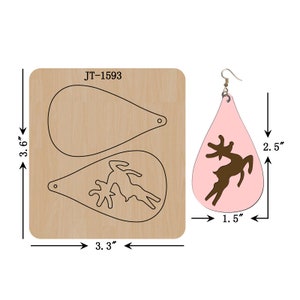 May include: A wooden die-cut for crafting teardrop-shaped earrings, measuring 3.6" x 3.3". The die features two teardrop outlines and a deer silhouette. A finished pink earring with a brown deer design is shown, measuring 2.5" x 1.5".