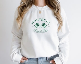 Puede incluir: Sudadera blanca con un gráfico de bandera a cuadros verde y blanca y el texto "Montreal Paddock Club Est. 1978 Fórmula Uno"