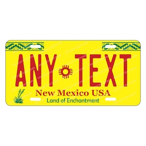 May include: Yellow license plate with green and red trim. The plate has a stylized sun symbol and the text "ANY TEXT" in red. The text "New Mexico USA Land of Enchantment" is also on the plate.