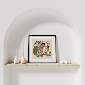 May include: A framed print of an ancient Egyptian scene depicting a man hunting birds with a bow and arrow. The scene is painted in vibrant colors and includes details like reeds, water, and other birds.
