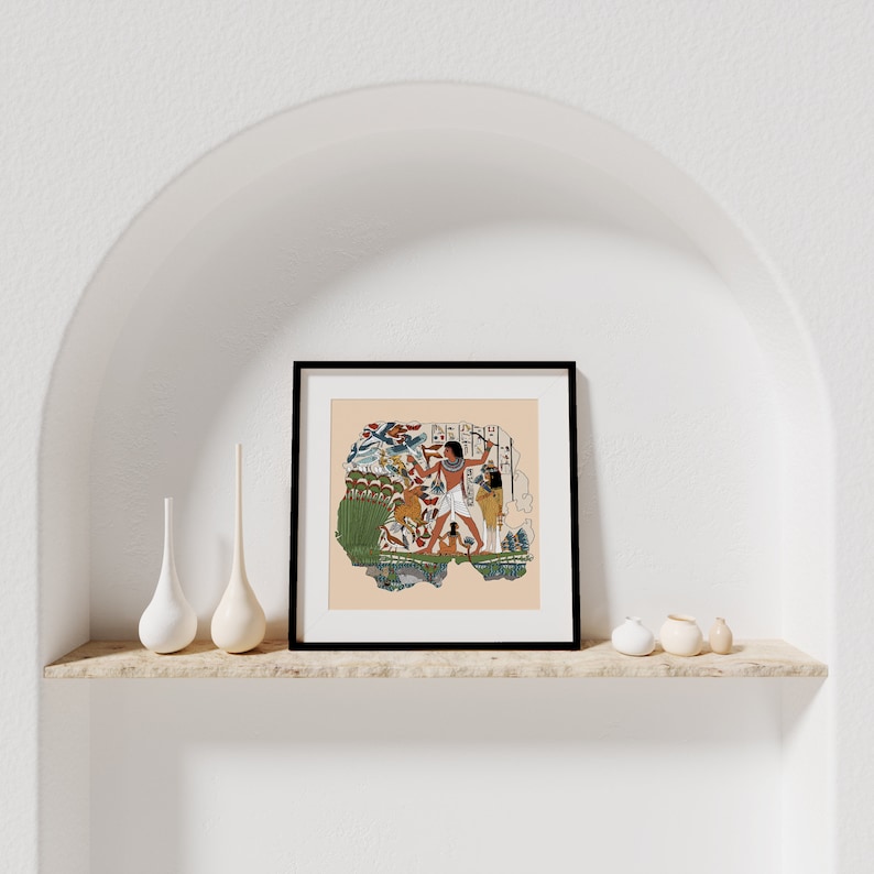 May include: A framed print of an ancient Egyptian scene depicting a man hunting birds with a bow and arrow. The scene is painted in vibrant colors and includes details like reeds, water, and other birds.