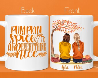 May include: White ceramic mug with a fall-themed design. The back of the mug reads "Pumpkin Spice and Everything Nice". The front of the mug features two women sitting under a tree with fall leaves. The text "Lola" and "Chloe" are written below the women.