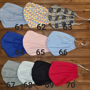 May include: Ten different fabric face masks in various colors and patterns, including blue, pink, gray, black, and red. The masks are numbered 61 through 70.