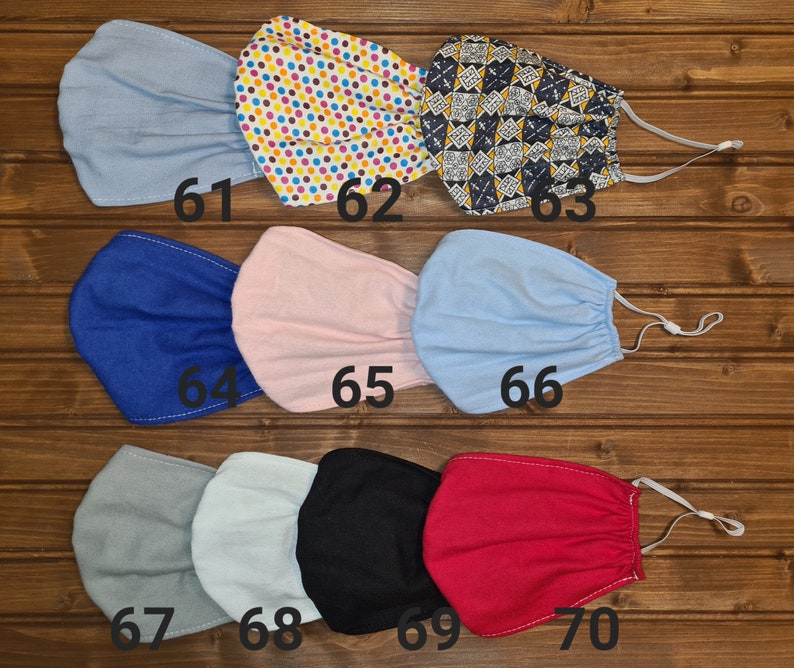 May include: Ten different fabric face masks in various colors and patterns, including blue, pink, gray, black, and red. The masks are numbered 61 through 70.