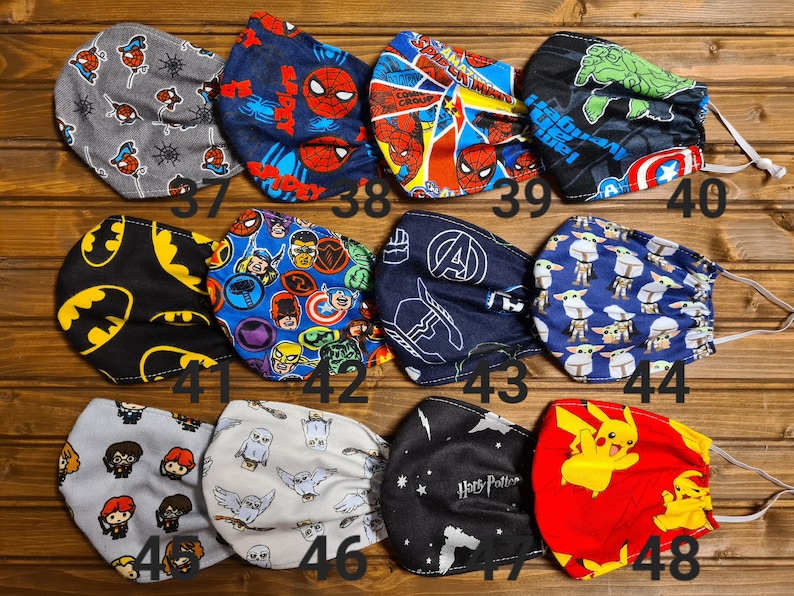 May include: A set of 12 colorful fabric face masks featuring various cartoon characters, including Spiderman, Batman, Harry Potter, and Pikachu. The masks are numbered 37 through 48.