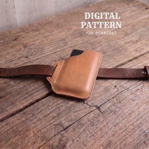 May include: A tan leather belt pouch with visible white stitching, threaded onto a dark brown leather belt. The text DIGITAL PATTERN PDF DOWNLOAD is printed in white above the pouch. The pouch has a rectangular shape with a curved top edge.