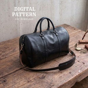 May include: A black leather duffel bag with two top handles, a detachable shoulder strap, and silver-toned metal hardware. The text DIGITAL PATTERN PDF DOWNLOAD is visible in the upper left corner of the image.