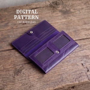 May include: A purple leather wallet with a snap button closure, featuring multiple card slots and two rectangular clear windows for identification. The text DIGITAL PATTERN PDF DOWNLOAD is visible in the upper left corner of the image.