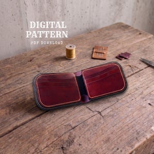 May include: A deep red leather bifold wallet with visible stitching and multiple card slots. The image includes the text DIGITAL PATTERN PDF DOWNLOAD, a wooden spool of thread, a small leather tool, and leather scraps.