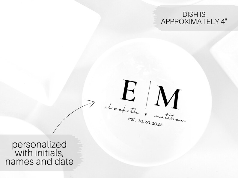 May include: White ceramic dish with black lettering. The dish is personalized with the initials "E" and "M", the names "elizabeth" and "matthew", and the date "est. 10.20.2022". The dish is approximately 4 inches in diameter.