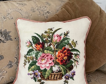 Cushion cover of a hand embroidered cross stitch of a garden floral bouquet in a wicker basket