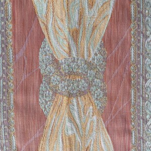 May include: Close-up of a textured fabric with a repeating pattern. The design features a central motif of intertwined shapes in shades of gold, green, and white, set against a reddish-brown background. The edges have a decorative border.