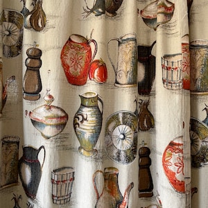 May include: A beige fabric curtain with a repeating pattern of various kitchen items, including pitchers, teapots, and bowls. The items are painted in shades of brown, red, green, and blue.