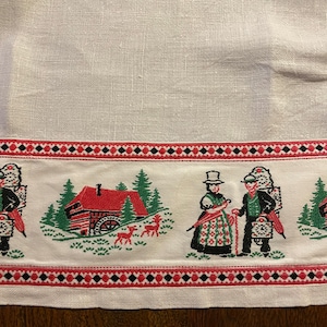 Delightful pure white small vintage linen tablecloth with embroidered Swiss folk art scenes