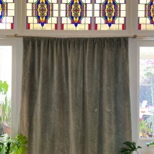 Curtain antique green velvet colour faded with old age
