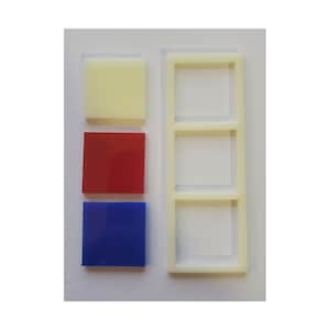 May include: Three square color samples, one white, one red, and one blue, are displayed next to a white plastic frame with three square openings.