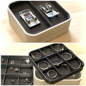 May include: A set of three ceramic mugs with a speckled, matte finish. The mugs are in shades of cream, light gray, and dark gray. Each mug has a simple, minimalist design and a rounded handle.