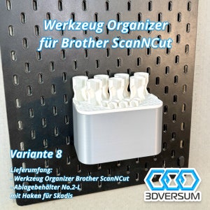 May include: A silver and white tool organizer for Brother ScanNCut, mounted on a black pegboard. The organizer has multiple compartments for tools. Text on the image reads "Werkzeug Organizer f&uuml;r Brother ScanNCut" and "Variante 8".