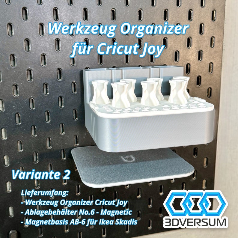 May include: A gray 3D-printed tool organizer for Cricut Joy, mounted on a black pegboard. The organizer has multiple white holders and a magnetic base. Text on the image reads "Werkzeug Organizer f&uuml;r Cricut Joy" and "Variante 2".