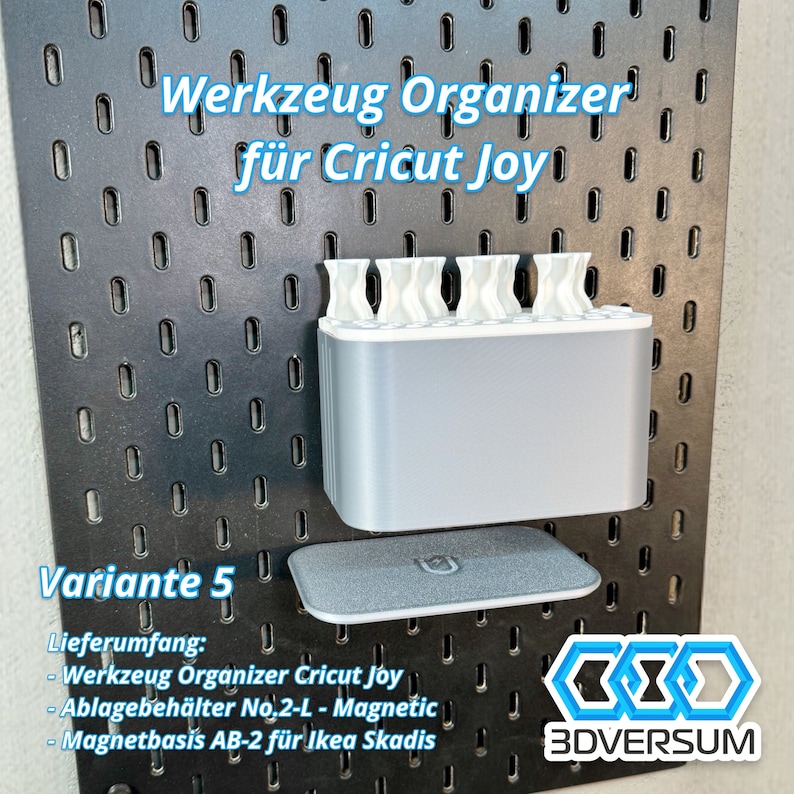May include: A gray and white tool organizer for Cricut Joy, mounted on a black pegboard. The organizer has multiple compartments and includes a magnetic storage tray. Text on the image reads "Werkzeug Organizer f&uuml;r Cricut Joy" and "Variante 5".