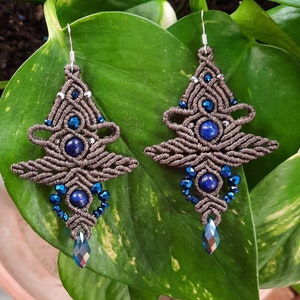 May include: A pair of brown macrame earrings with blue lapis lazuli stones and crystal accents.