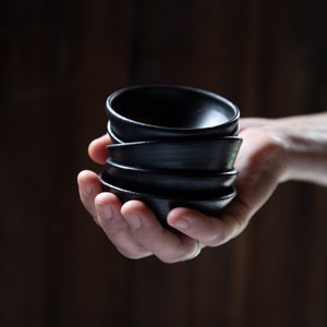 Set of six small black bowls