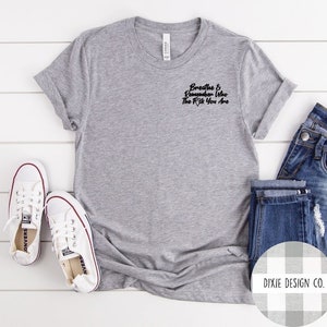 May include: Gray t-shirt with a black graphic that reads "Breathe & Remember Who The F*ck You Are".